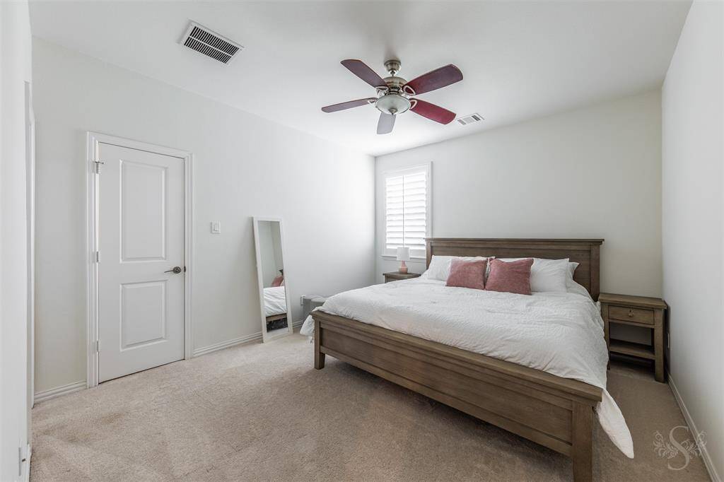 Secondary bedroom providing the space you need for a king bed and any additional furnishings needed including student desks and bookcases. Featuring a high ceiling, plush carpet for comfort and window with plantation shutters.