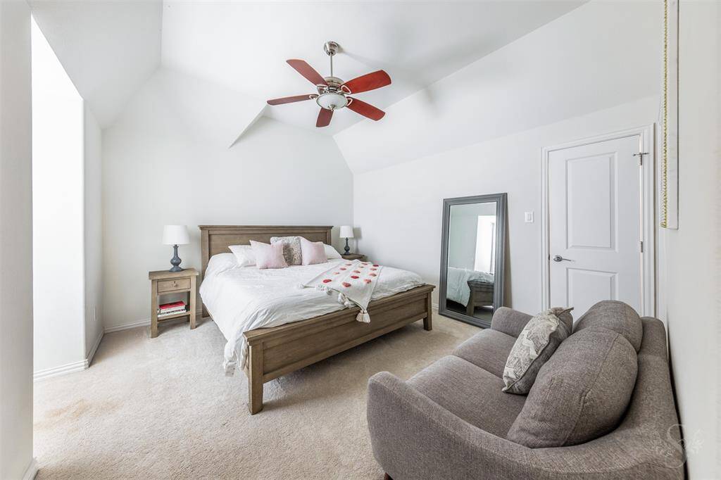 Secondary bedroom providing the space you need for a king bed and any additional furnishings needed including student desks and bookcases. Featuring a high angled ceiling, plush carpet for comfort and window with plantation shutters.