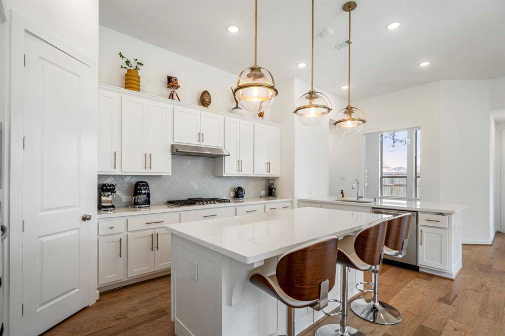 This stunning kitchen is perfect for everyday life as well as entertaining family and friends! Just off the kitchen, you will find a beautiful home office at the back of the home!