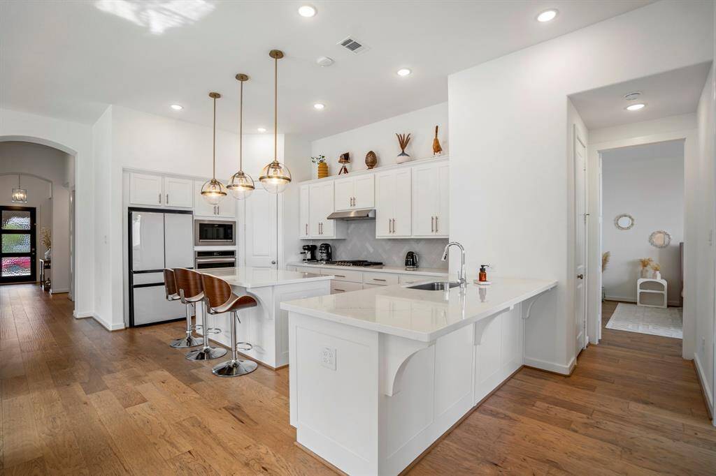 The private hallway just off the kitchen leads to the primary retreat!