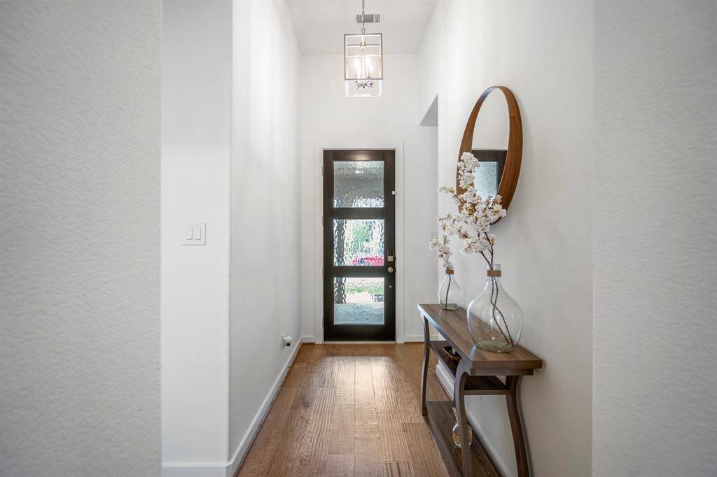 Heading back to the front of the home, you find another view of the open entry way, leading to the media room and secondary bedrooms.