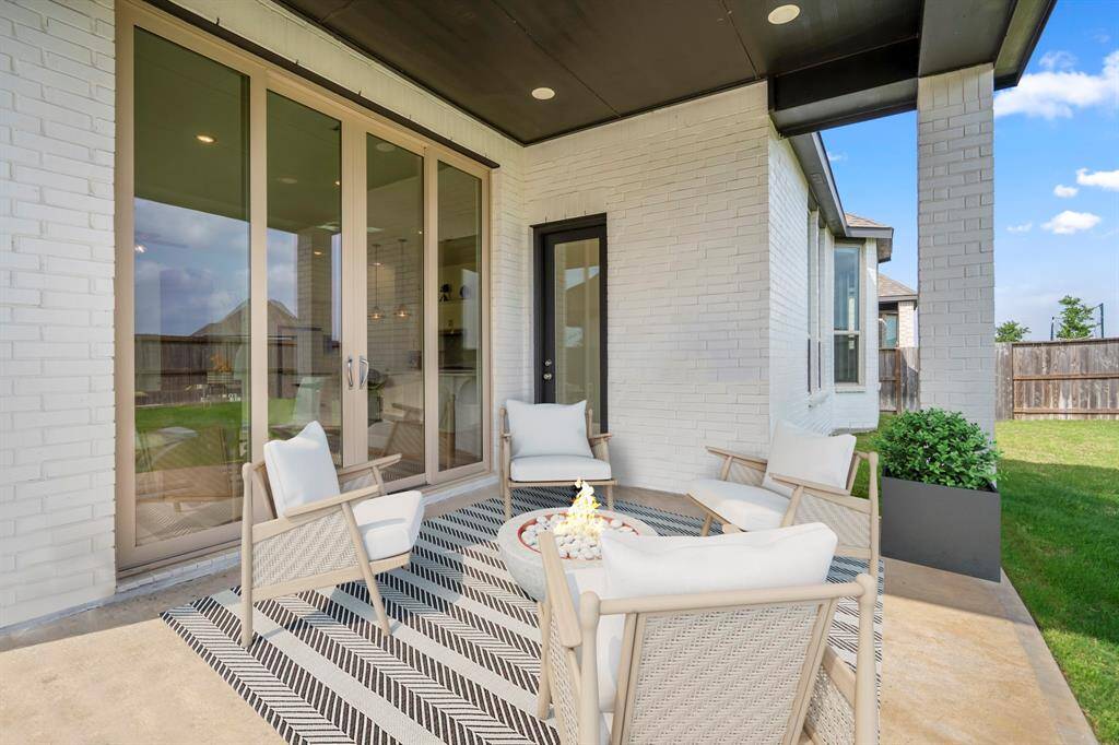Seamlessly blending indoor and outdoor living, this backyard features expansive sliding glass doors that connect the main living space to the stunning covered patio patio. It's complete with overhead stained paneling, recessed lighting, and plenty of space for a grill and outdoor furniture! *This photo has been virtually staged
