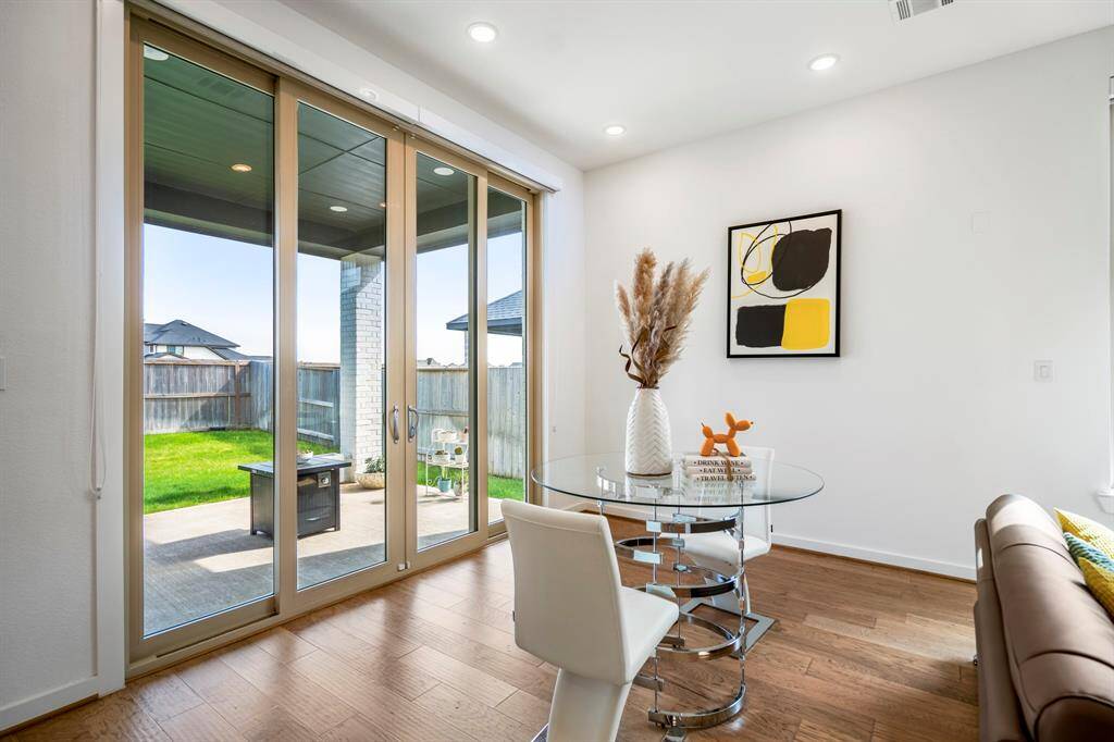 The living and dining area go beyond just an indoor entertaining space and can be opened up via sliding glass doors to an oversized patio! It's complete with recessed lighting and wood floors!