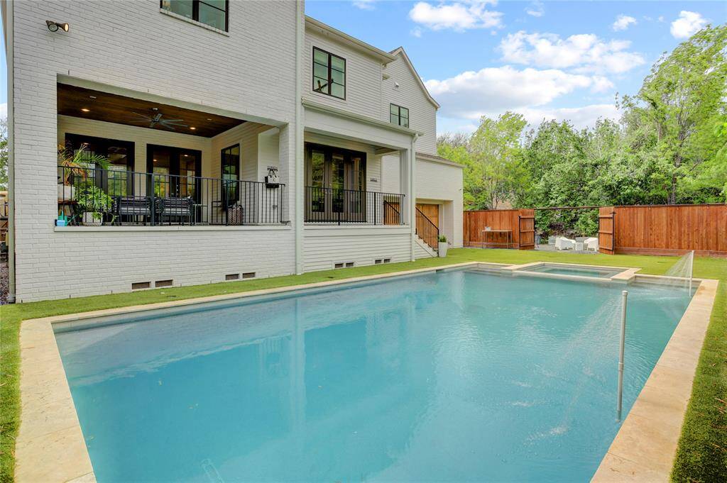 Backyard Oasis! Note that the garage opens to the backyard making it perfect for additional covered space for outdoor entertaining. Large heated pool, hot tub, turf for easy maintenance, large Back Patio and mature bamboo lining the back fence for added privacy.