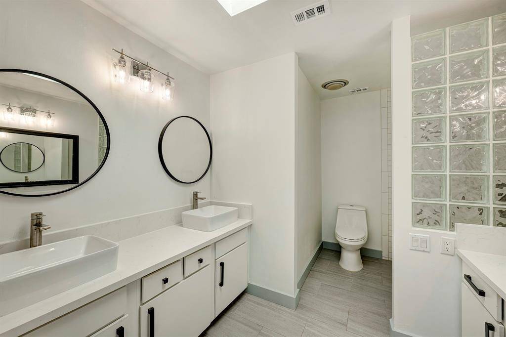 Primary bathroom has quartz counters (2025) and double sinks and a tub shower.