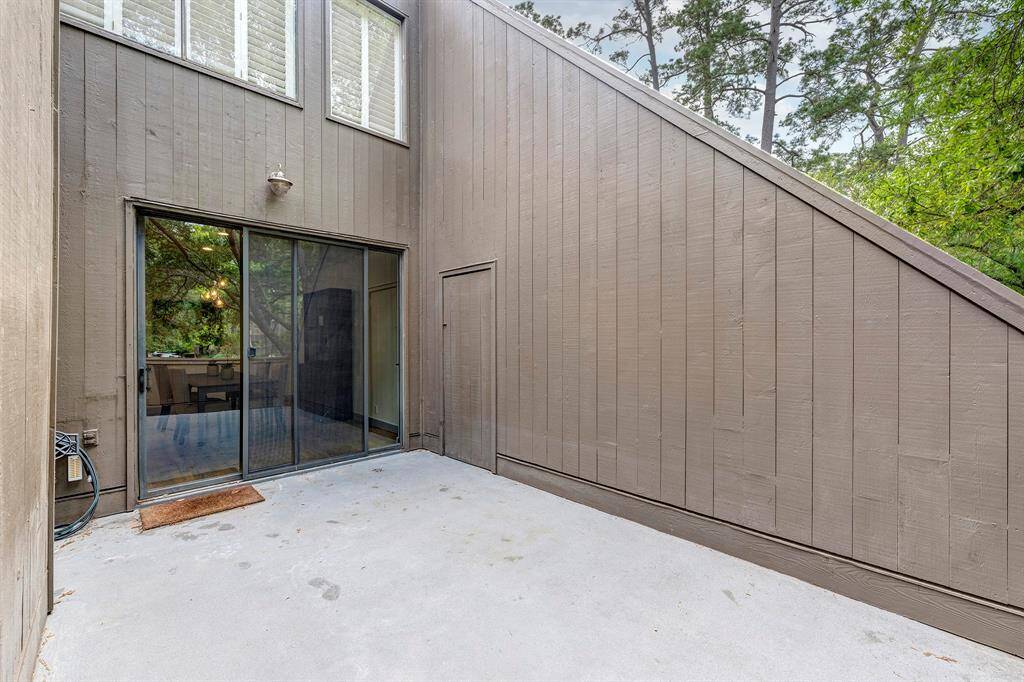 Large patio has outdoor storage unit.
