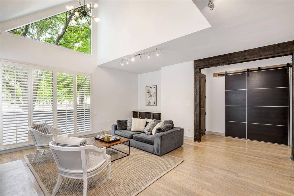Beautiful tree views and high vaulted ceiling create a spectacular living room! Quartz counter (2025) along back wall for serving and display space. Barn door in the entry access large closet.