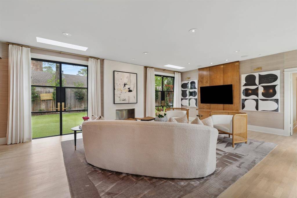 Another view of this incredible light filled family room. Custom ribbed double doors lead to the bedroom wing.