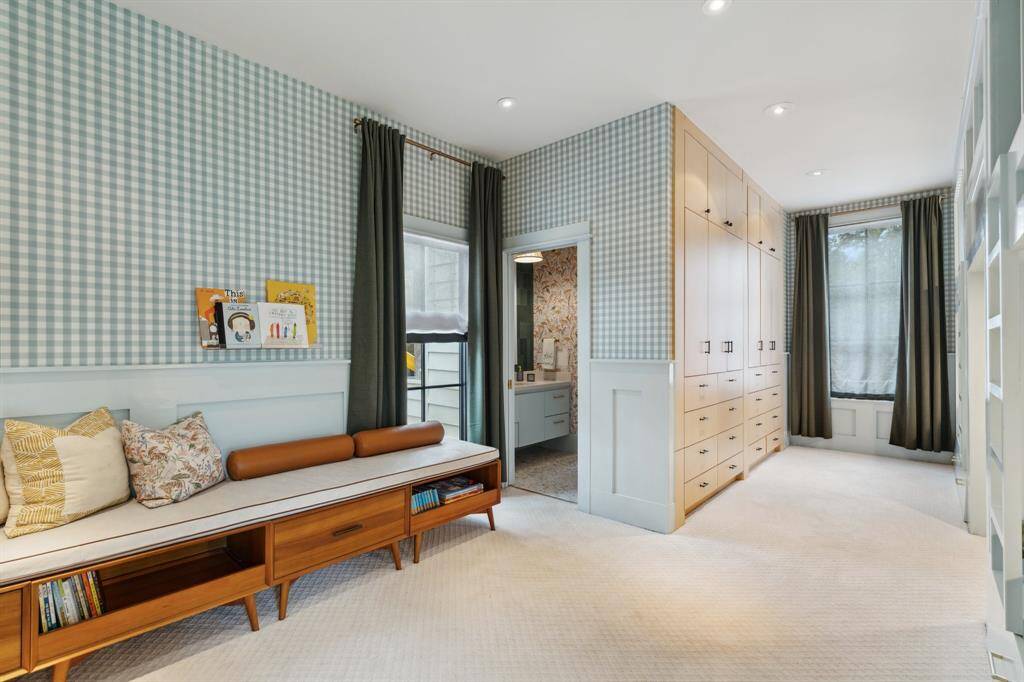 Another view showing this oversized bedroom with space to either keep the built in bunk beds or turn back into an oversized traditional bedroom. A wall of storage/closets completes this playful yet practical space.