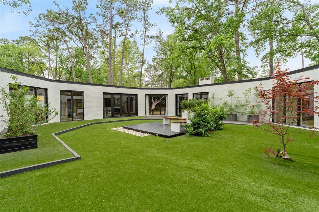 Designed for both relaxation and entertainment, every inch of the backyard has been thoughtfully planned. The home wraps around the backyard, offering multiple egresses from the formal living room, kitchen, family room, and primary bedroom for easy access to the outdoor spaces. This tranquil courtyard has a built-in bench, patio, and large turfed area provides ample space for entertaining guests.