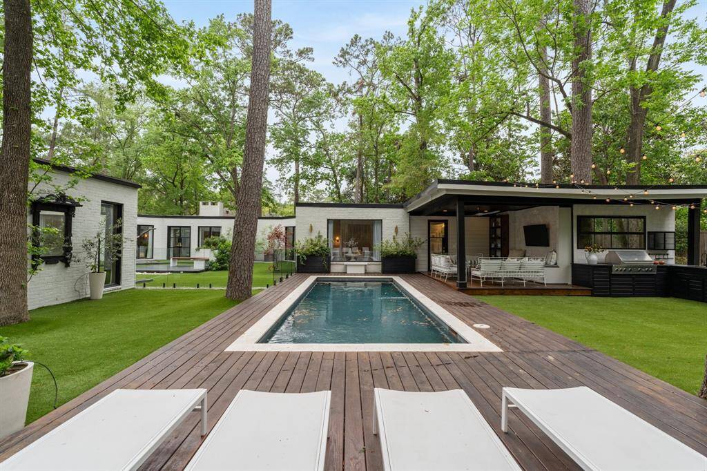 From the courtyard, enter through the custom glass enclosure into this stunning heated in-ground pool with deck space for patio furniture and planter boxes surrounding the area.