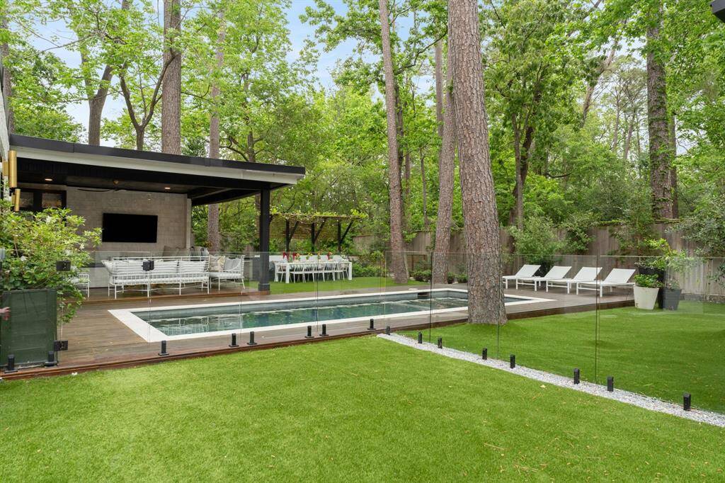 This incredible pool sits in the heart of the backyard surrounded by turfed greenspace, outdoor kitchen, covered patio, mini golf and playground area, outdoor movie deck, chess area and more!