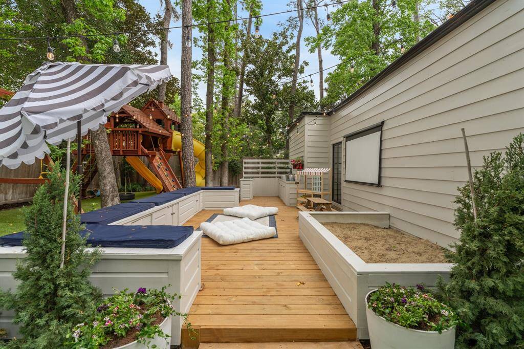 This custom-built deck and projector area is ready for entertaining and movie nights! A large gardening box for the kids to try their hand at growing herbs! Note: this deck area is prepped with a concrete slab and plumbing for a future addition!