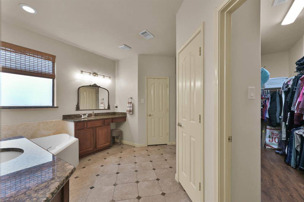 Granite Counters, recent light fixtures and mirrors update the Primary Bath that has two walk-in closets giving you lots of storage space.