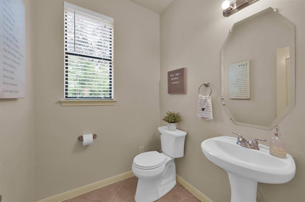 Off the Foyer and down a short hallway guests will appreciate the privacy of this Half Bath with a pedestal sink and window for extra light. The Sensi Digital thermostat is located in this hallway and is controlled on your phone through an app.