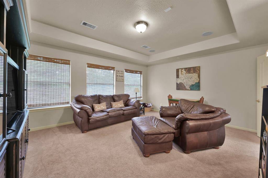 Just inside the Juliet balcony is the Game Room. It has a tray ceiling, is pre-wired with ceiling speakers, overlooks the back yard and has plenty of room for couch, large chair and an activity table.