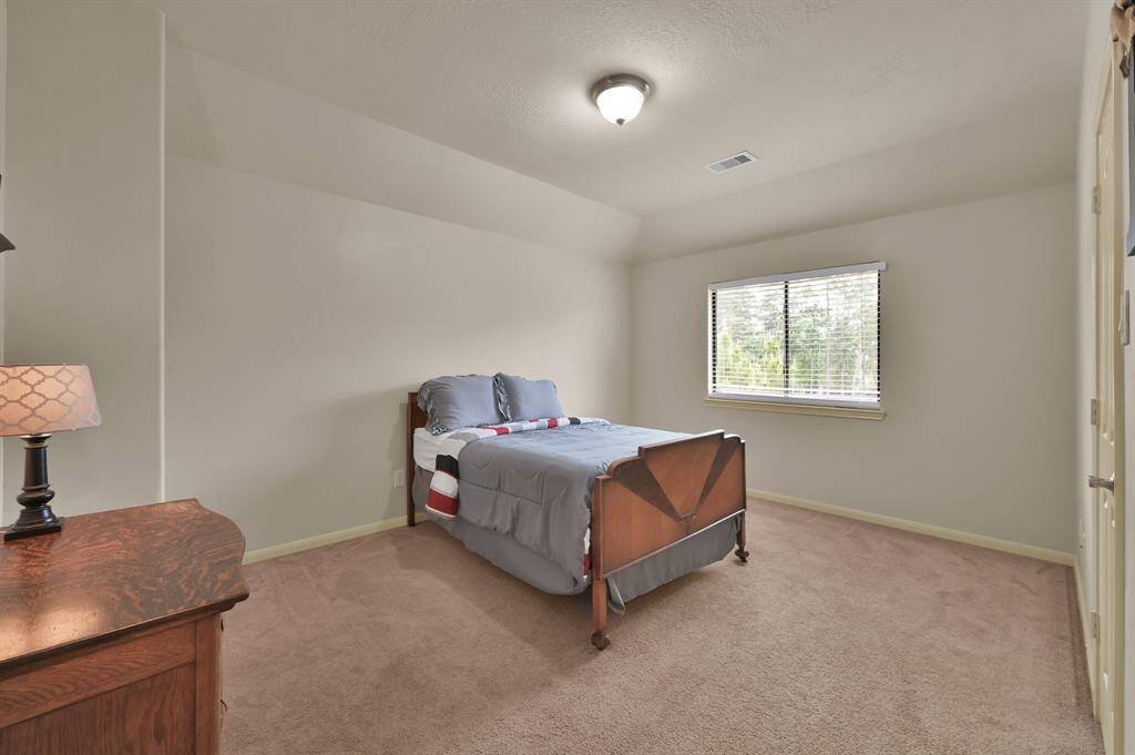 This is a Secondary Bedroom at the rear of the home. It has a walk-in closet  and connects directly to a full bath.