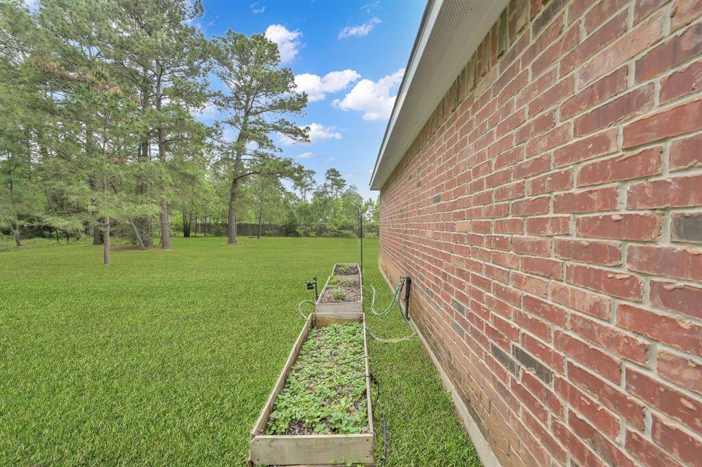 Behind the Garage are Garden Beds with a drip water system, timer and motion-activated deer deterrent. The seller has already planted some fruits and veggies for you to harvest after you move in!