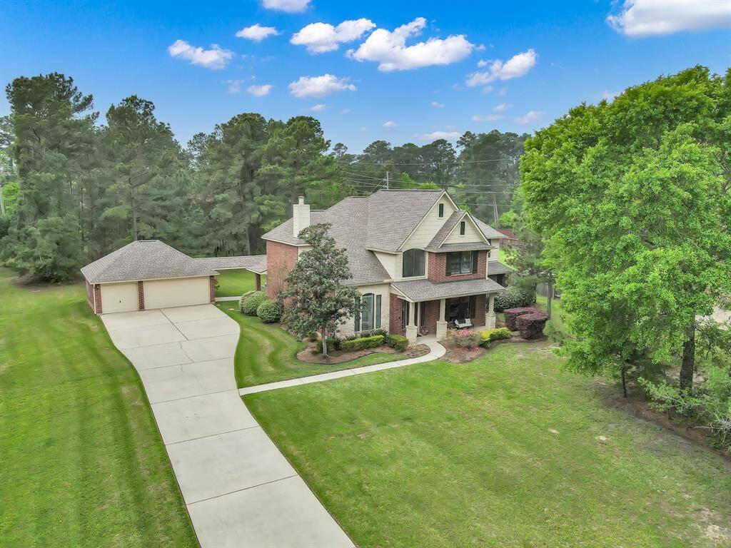 This three-car garage has recently installed garage door (2025) with workbench and shelving. This long driveway provides lots of parking spaces when you entertain. A sprinkler system on the front and sides of the home keep the lawn watered with a wi-fi enabled sprinkler controller replaced in 2023.