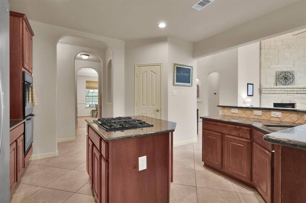 Frigidaire double ovens allows for easy meals, especially during large gatherings. And just through the archways you can see the Formal Dining Room.