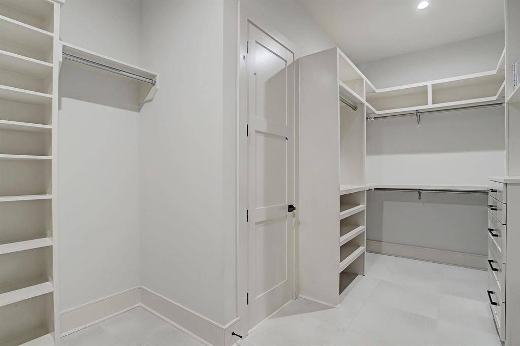 Another view of the primary suite his and her closets.