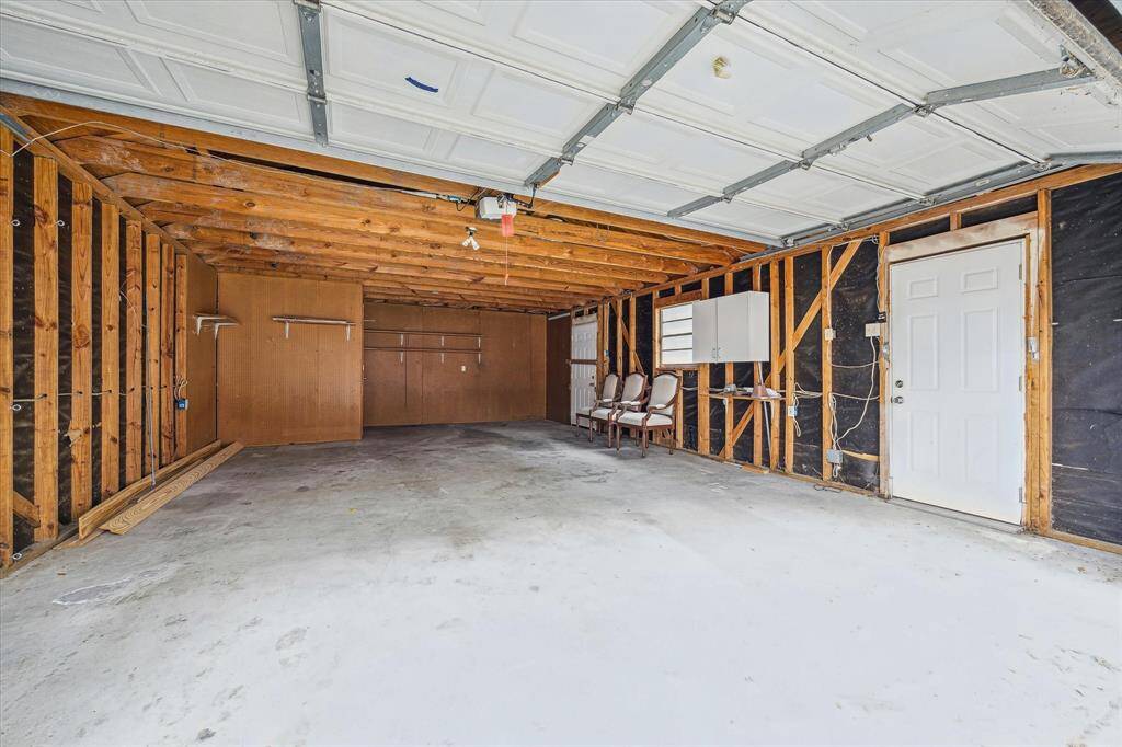 Big oversized garage with a closed in closet at the back.
