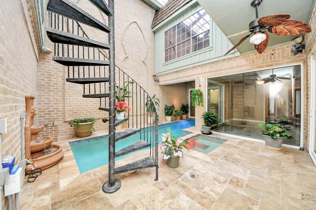 The pool area includes a spiral staircase to upstairs bedrooms and apartment
