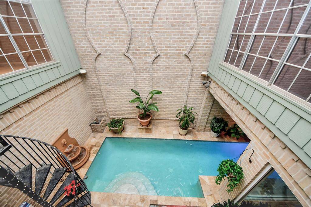 Off the primary suite, you can walk out to the balcony to look at your pool oasis