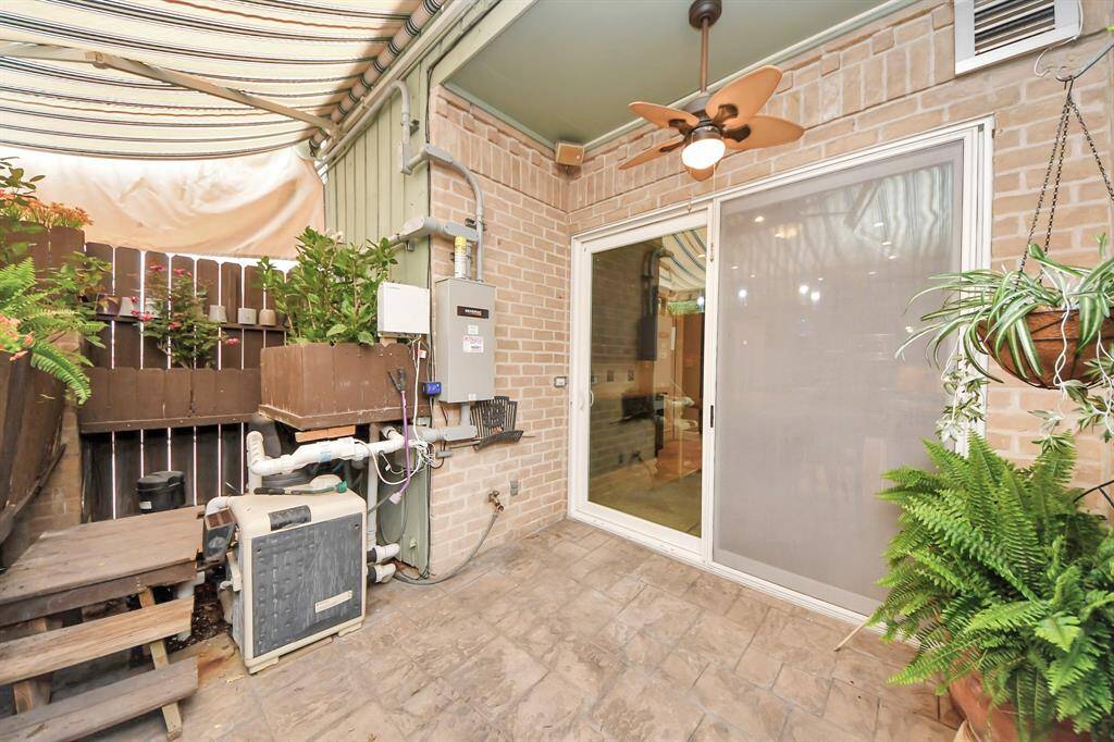 Back patio has retractable awning to keep cool or open for healthy sunlight for plants