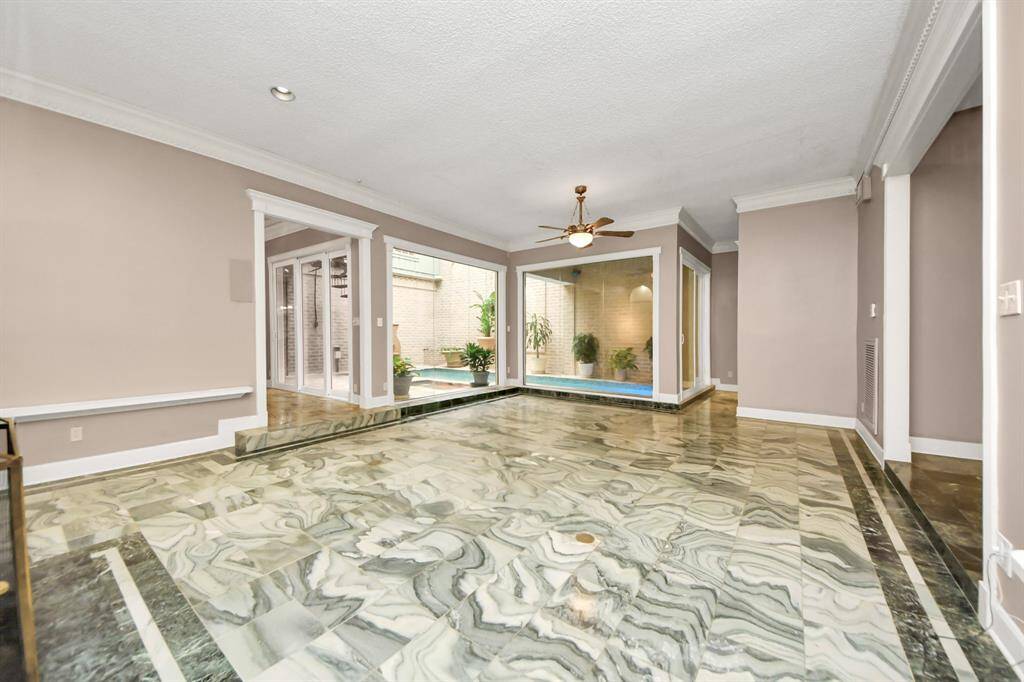Your living room has custom wet bar and overview of the indoor/outdoor pool oasis