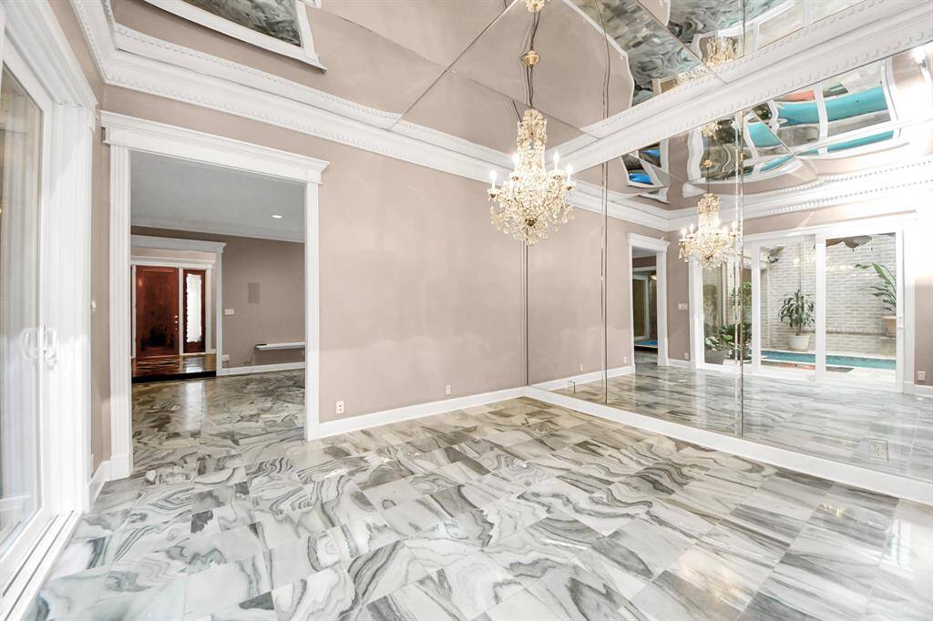 The formal dining room with elegant crown molding can also be used as an office and game room
