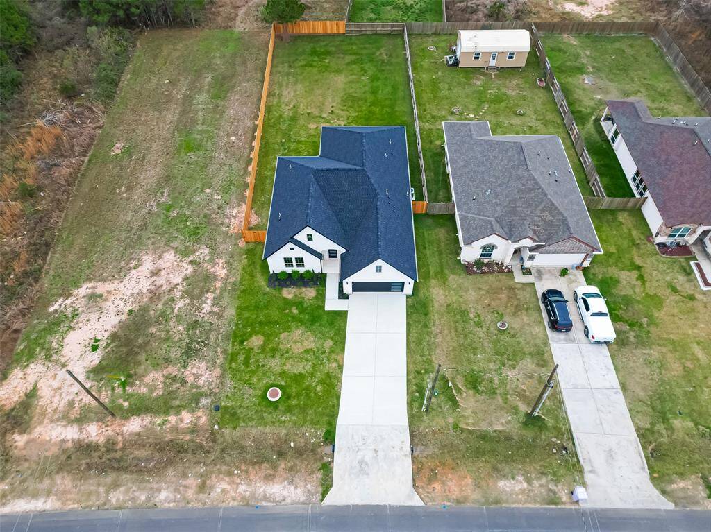 Appreciate the spacious long driveway with room for multiple cars. (Note: The grass has been digitally enhanced to show potential.)