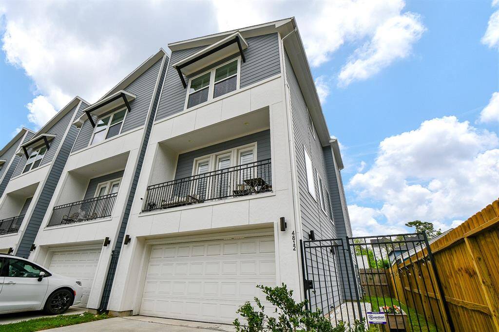 Wooden privacy fencing and wrought iron gating secure this special property.