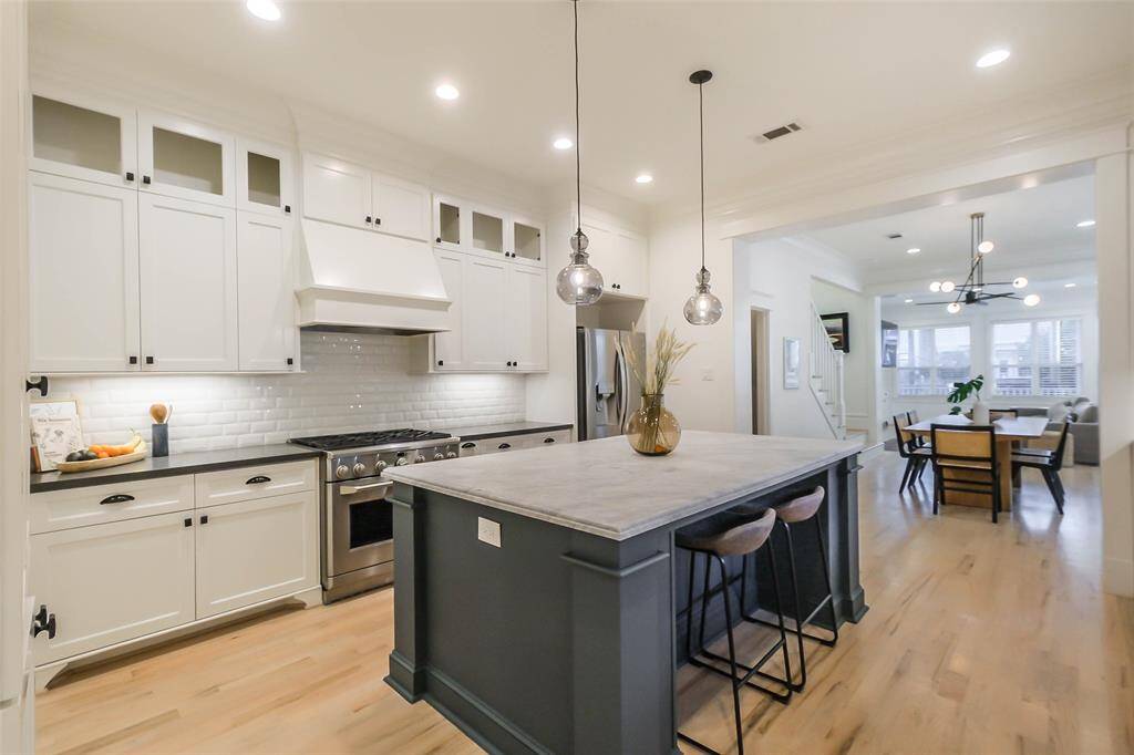 The kitchen is open and bright and leads into a dining and living area.
