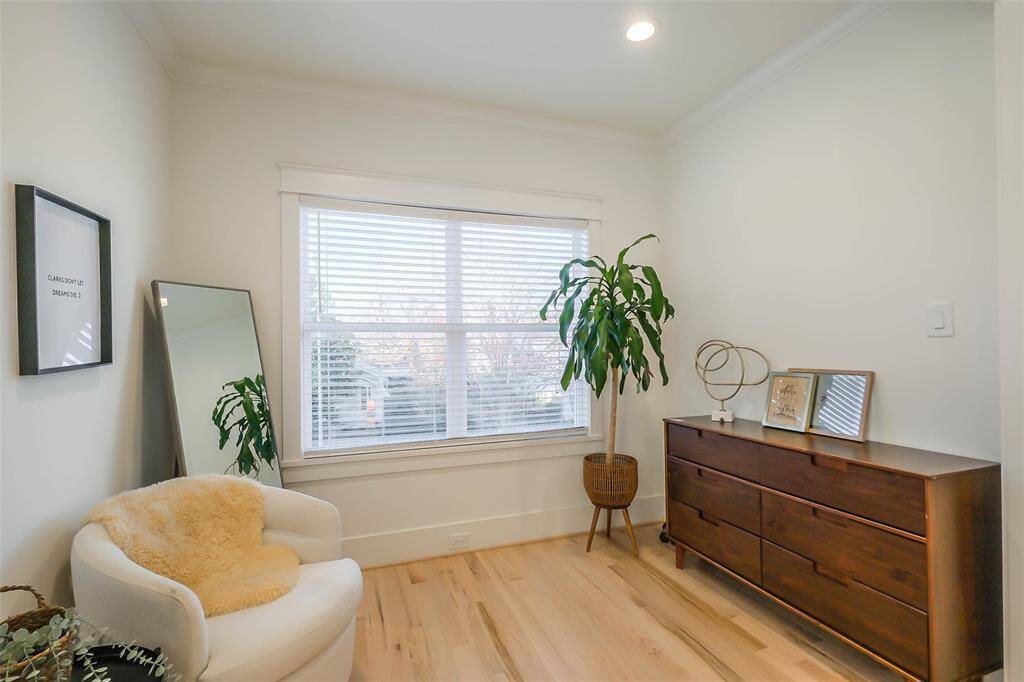 This cozy sitting area in the Primary Suite provides ample space to relax and enjoy the views from the large windows.