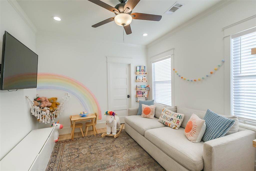 Secondary bedroom upstairs with ceiling fan and lots of light.