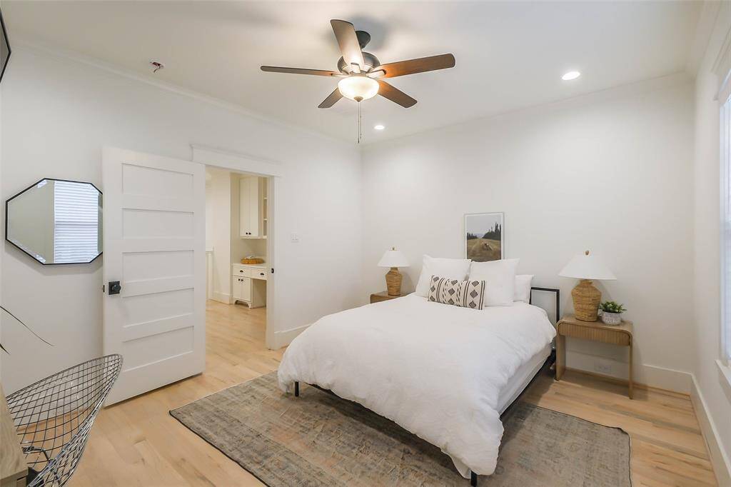 Spacious bedroom has walk in closet, ceiling fan and also has wood floors.