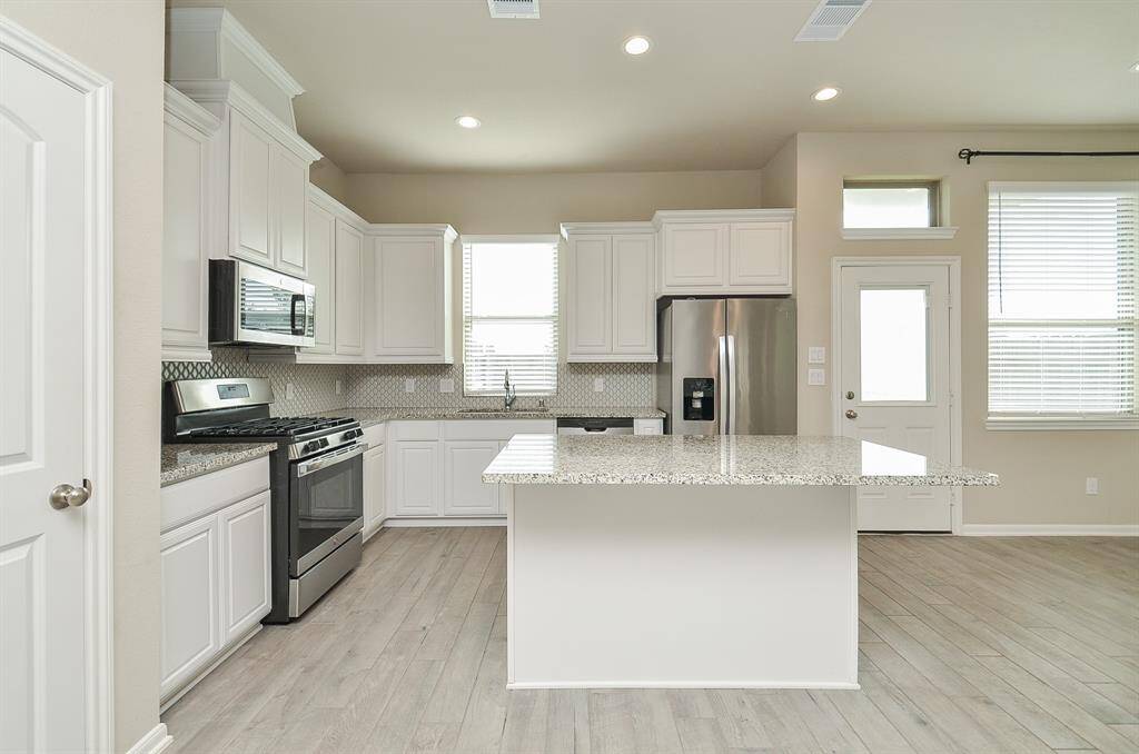 Another view of the kitchen featuring a large island - plenty of room to entertain