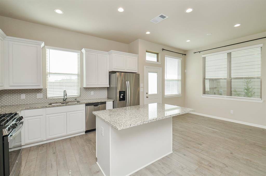 Another view of the kitchen with the breakfast area to the right