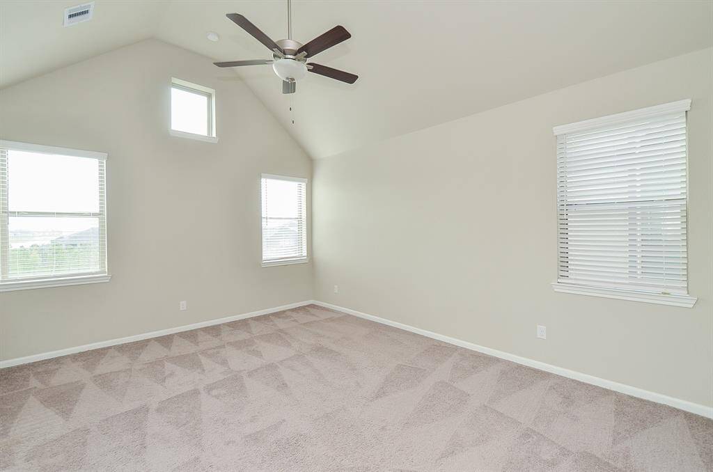 Primary bedroom upstairs with tons of natural light and high ceilings