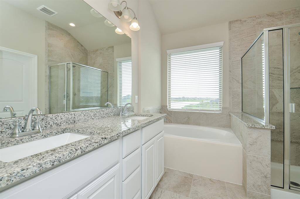 Primary bathroom with a water view