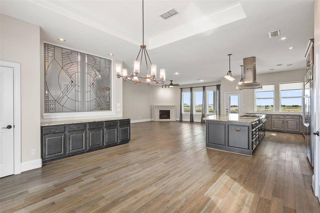 View from the front of the home looking towards the back. Elevator access is located behind the custom stained glass. The door to the left is a second pantry.