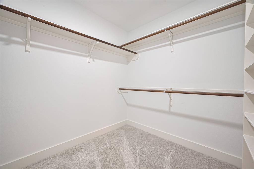 Plenty of space in this primary walk-in closet.