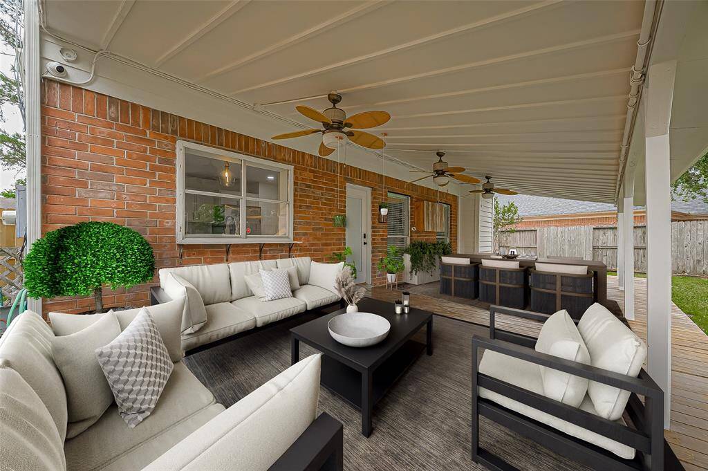 *Picture staged to show possibilities for the use of this amazing back porch* Showcasing fresh exterior paint in Swiss Coffee by BM & new light fixture! New window to be installed at kitchen sink as well! Hours of backyard fun await!