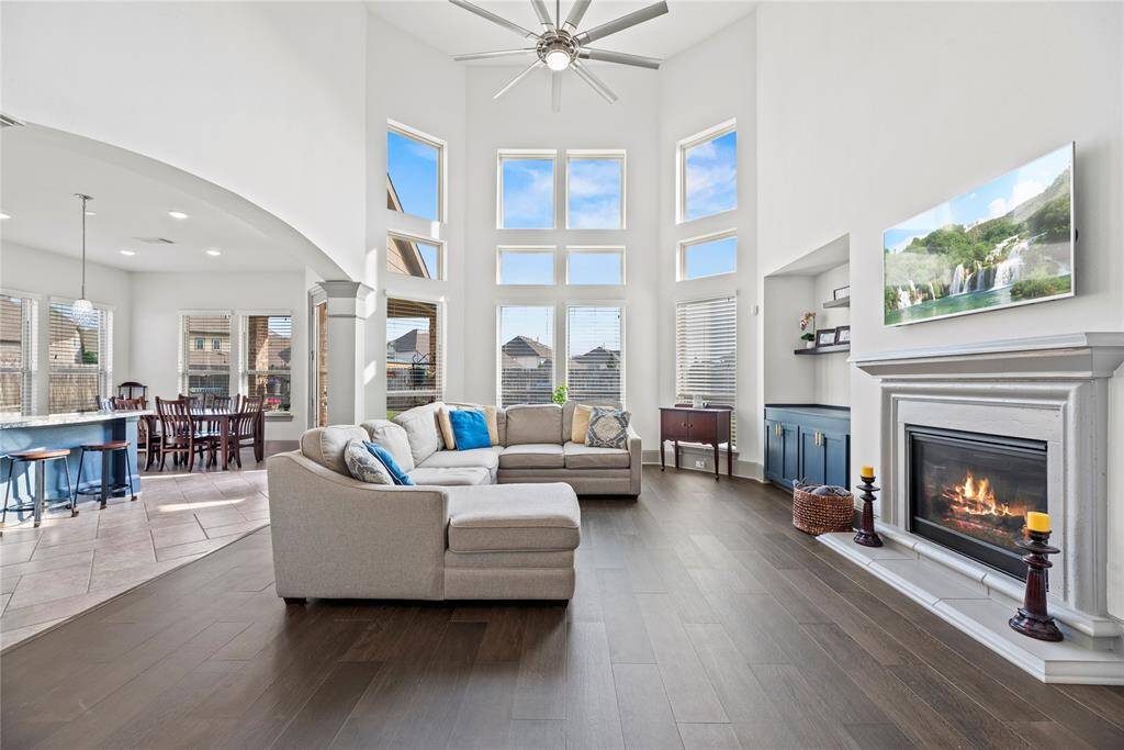 Living room with fireplace and incredible views of the backyard bringing in so much natural light.
