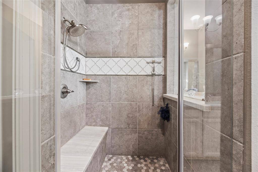 Primary bathroom walk in shower with gorgeous tiling and bench!