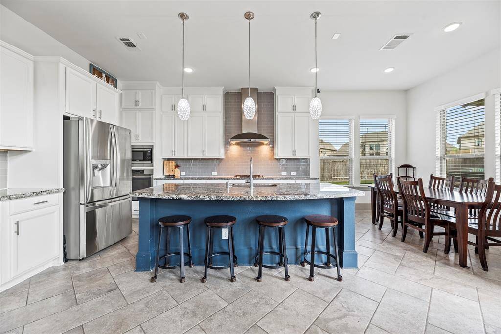 Kitchen with fantastic layout, huge walk in pantry, plenty of cabinets, large island and gorgeous countertops.