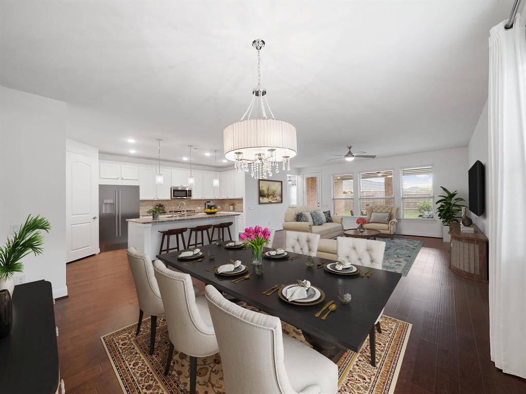 **Virtually staged**A view from the dining area toward the living room and kitchen.