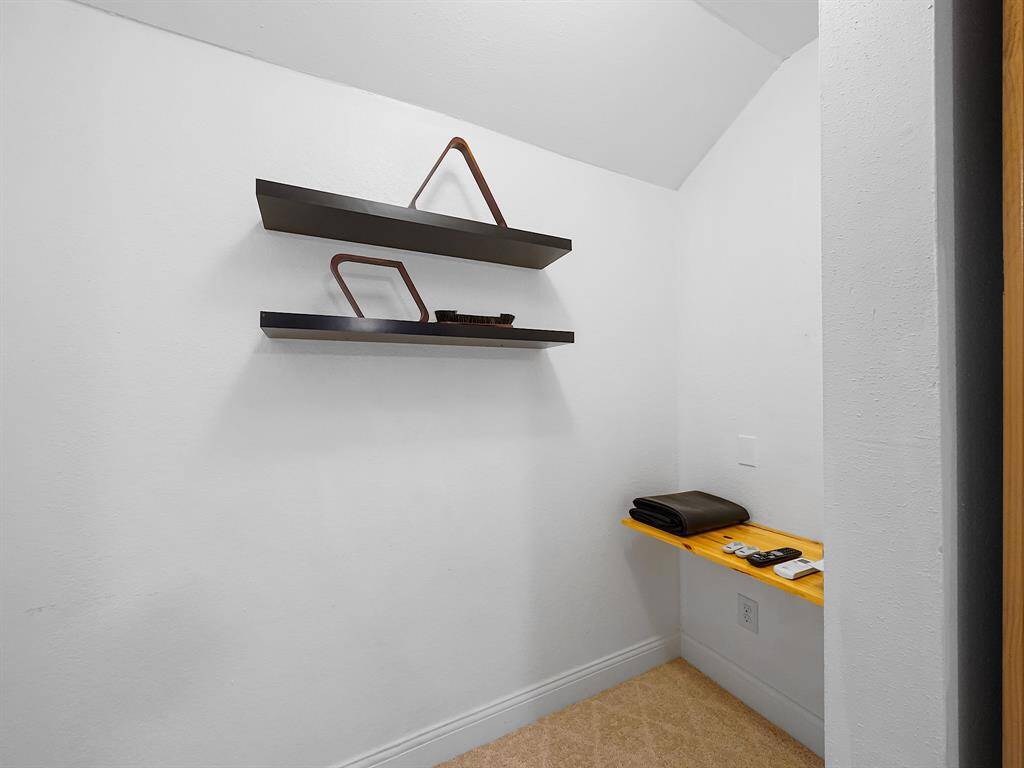 Closet with storage shelves behind the sliding barndoor.