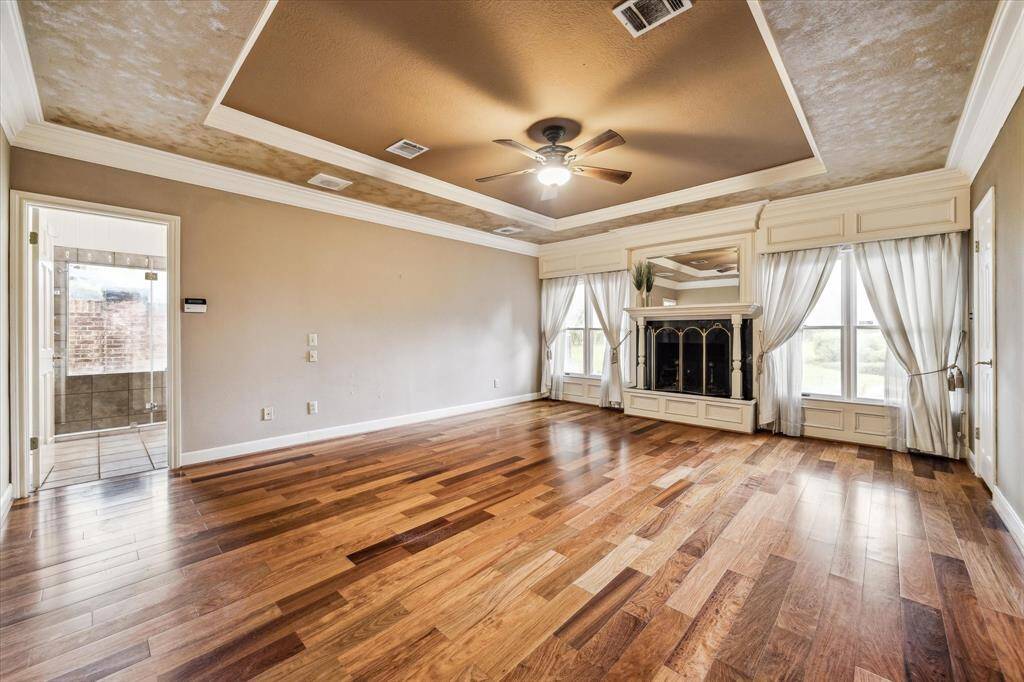 The primary bedroom is complete with a wood burning fireplace.